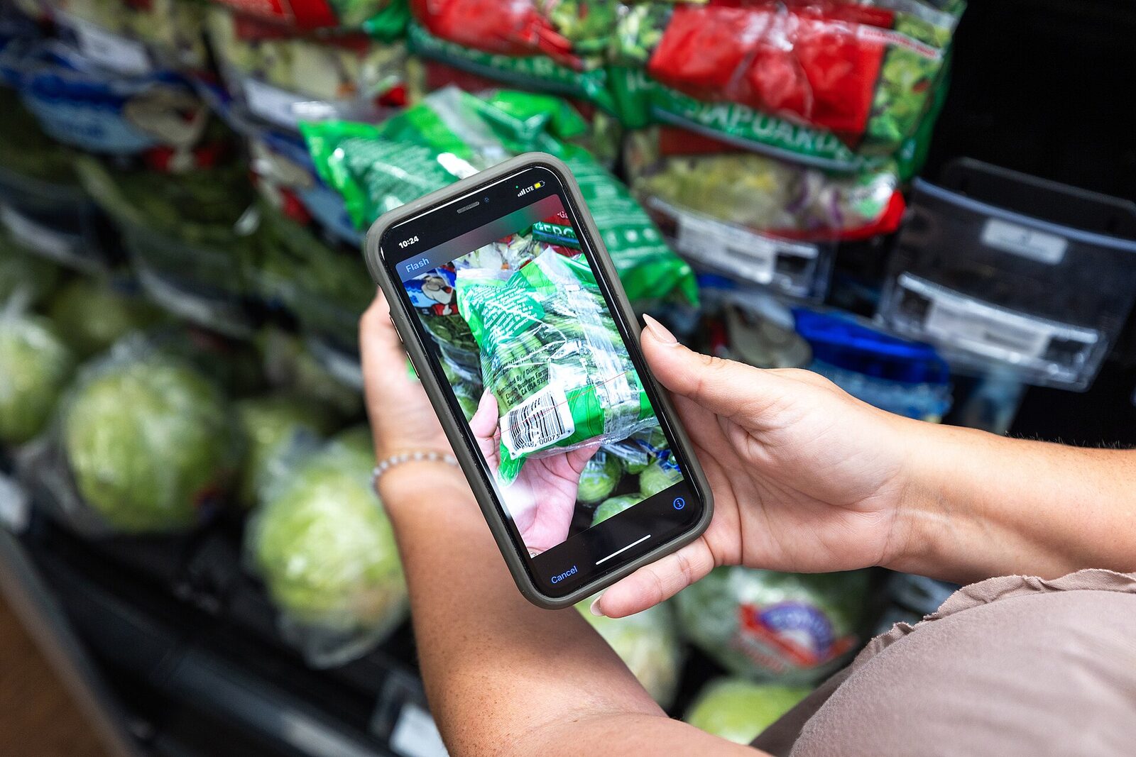 A shopper using a phone at the point of purchase